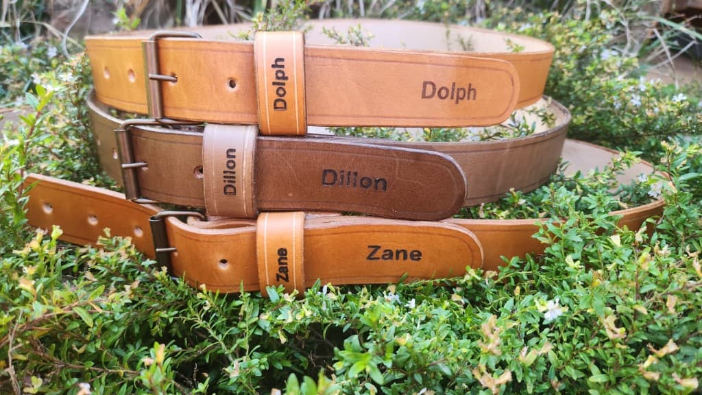 Custom handmade leather belts with personalised name embossing by Plaasjaap